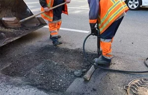 Potholes Repair In Asphalt Road
