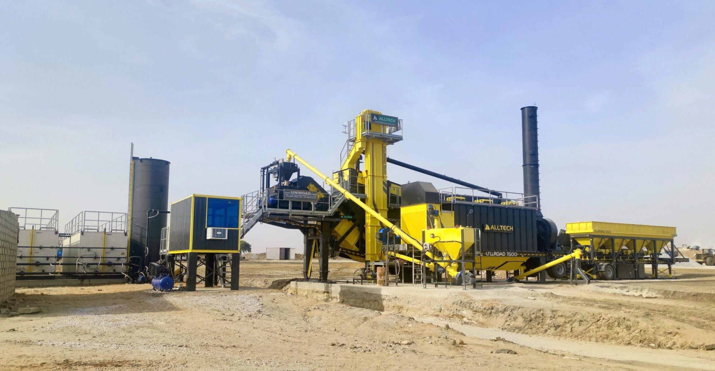 Mobile asphalt batch mix plant in operation at a construction site