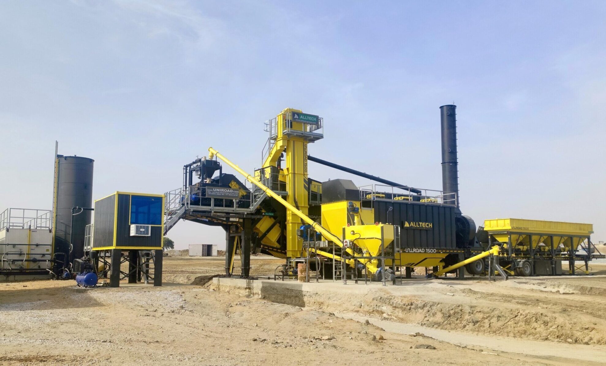 Mobile asphalt batch mix plant in operation at a construction site
